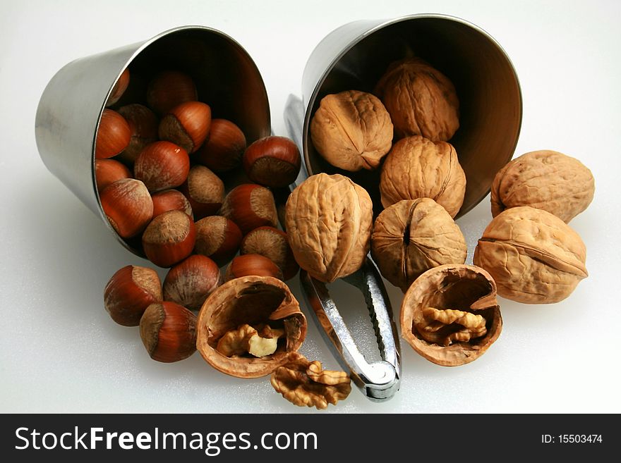 Basket of walnuts and hazelnuts after a walk in forest during autumn