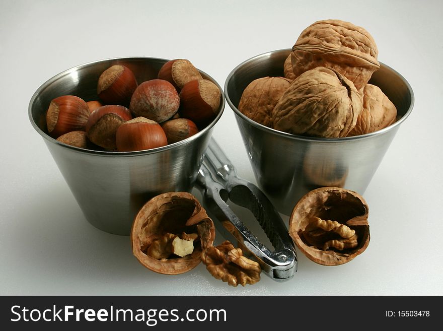 Basket of walnuts and hazelnuts after a walk in forest during autumn