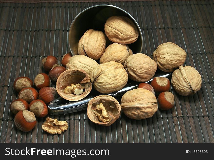 Basket of walnuts and hazelnuts after a walk in forest during autumn