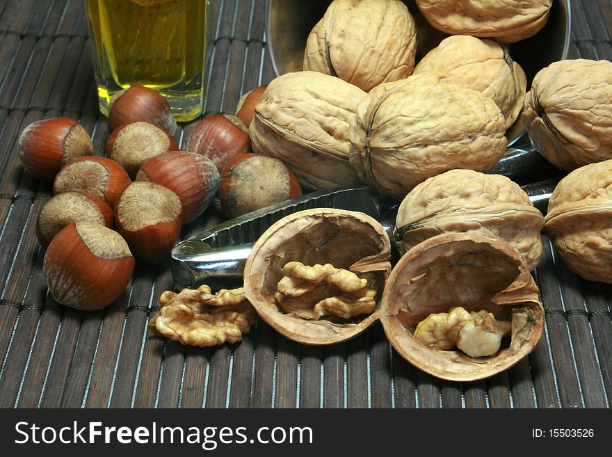 Basket of walnuts and hazelnuts after a walk in forest during autumn