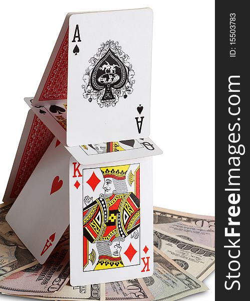 House of cards and money isolated on white background; symbol of financial crisis and housing market