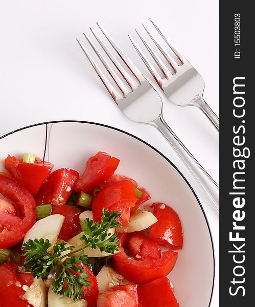 Fresh Homemade Tomato Salad Served on a White Plate with forks. Fresh Homemade Tomato Salad Served on a White Plate with forks