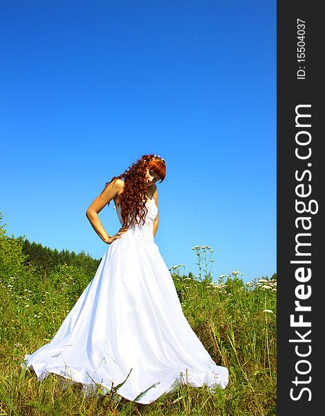 Bride in nature against the sky