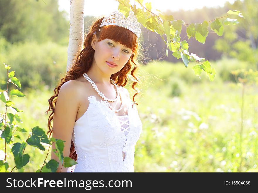 Beautiful girl near to a birch