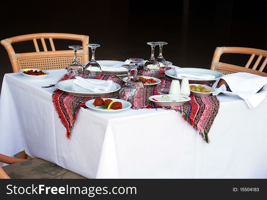 Outdoor table with served plate and wine glasses. Outdoor table with served plate and wine glasses