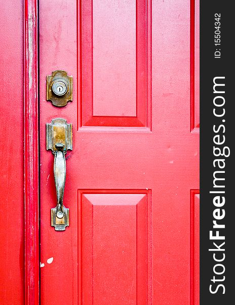 Red door with metal handle and lock