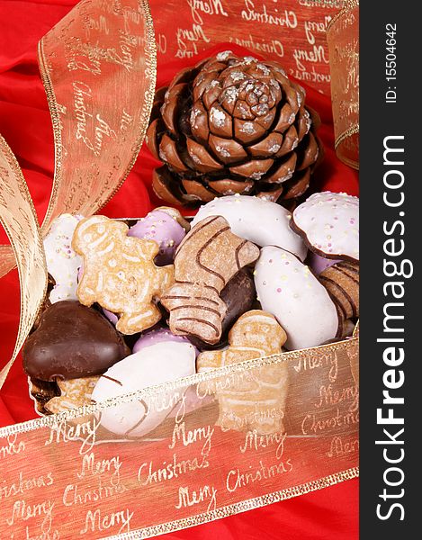 Assorted Christmas gingerbread cookies and Christmas decorations over a red background