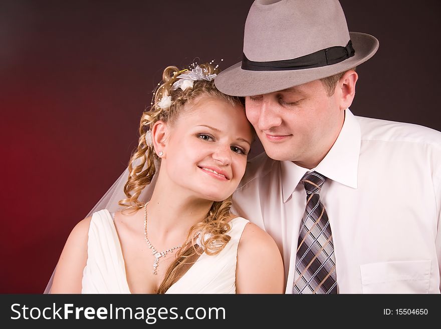 Photography of happy newly-wed is in a studio