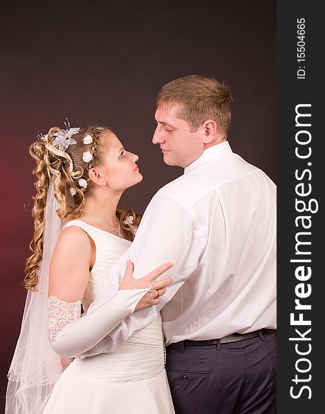Photography of happy newly-wed is in a studio