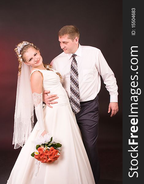 Photography of happy newly-wed is in a studio