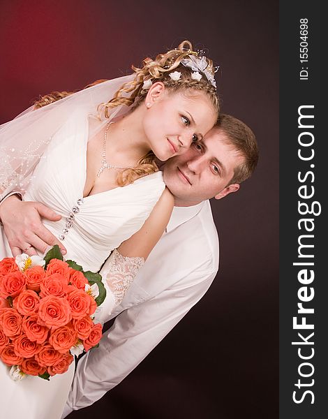 Photography of happy newly-wed is in a studio