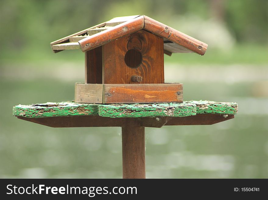 Wooden bird house with blurred background. Wooden bird house with blurred background.