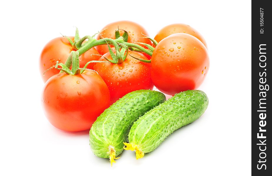 Branch of tomatoes and cucumbers isolated over white