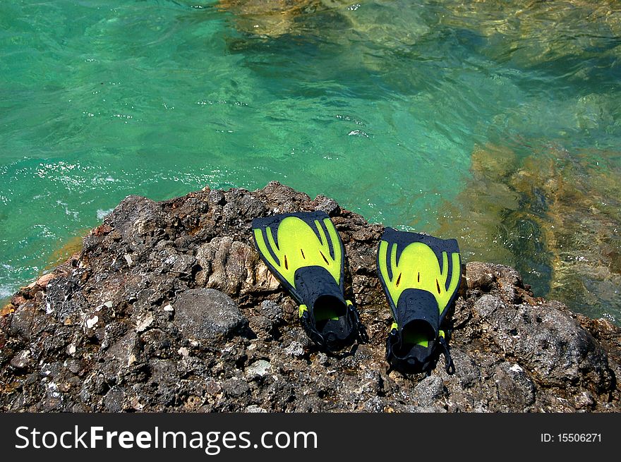 A pair of yellow fins on a rocky Montenegrin beach. A pair of yellow fins on a rocky Montenegrin beach