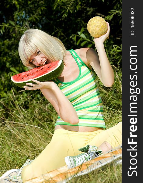 Woman with melons at a picnic