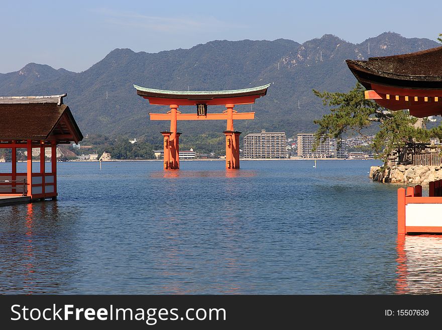 Beautiful Torii in Miyajima at high tide with mountains in background. Beautiful Torii in Miyajima at high tide with mountains in background