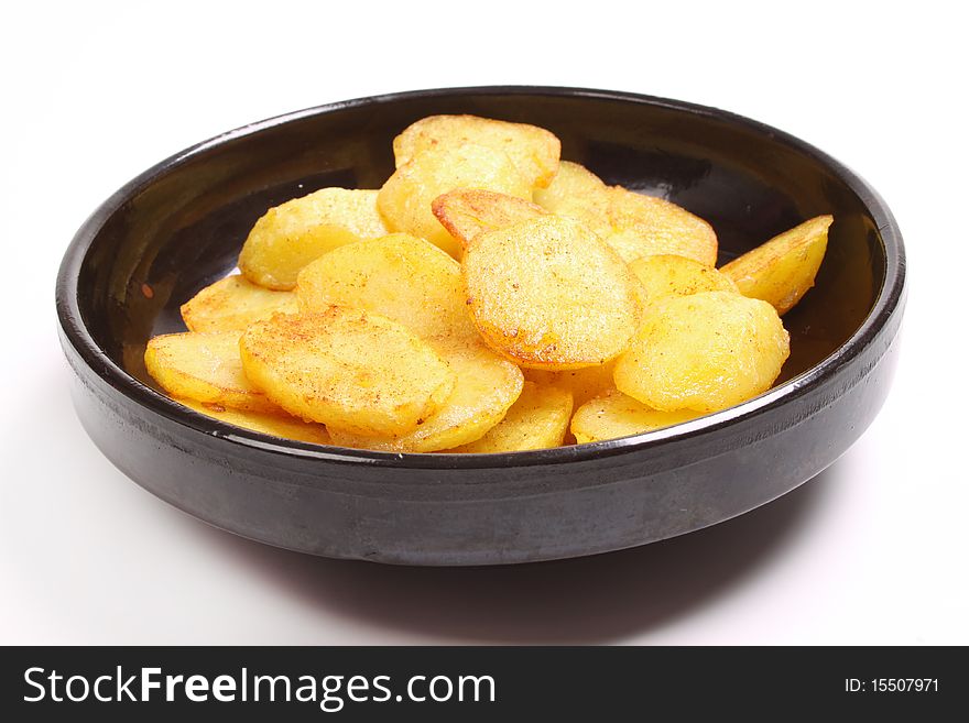 Baked potatoes in dish against a white background