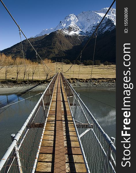 Swing Bridge crossing the Matukituki River. Mount Aspiring National Park. South Island, New Zealand. Swing Bridge crossing the Matukituki River. Mount Aspiring National Park. South Island, New Zealand.