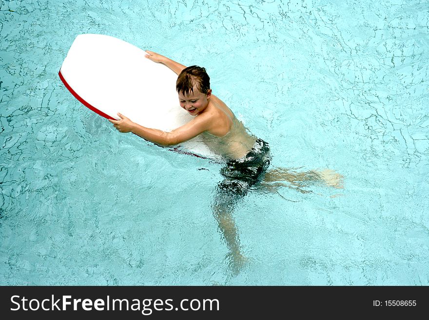 Boy On Surfboard In Pool