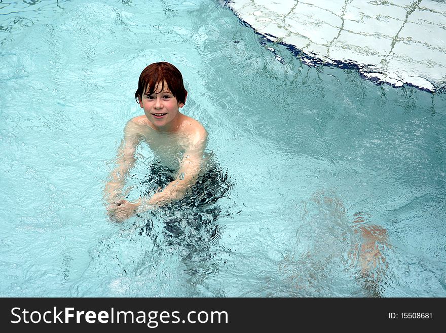 Young boy has fun in the public indoor pool