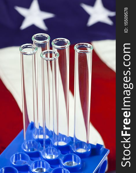 A rack of test tubes with an american flag in the background. A rack of test tubes with an american flag in the background