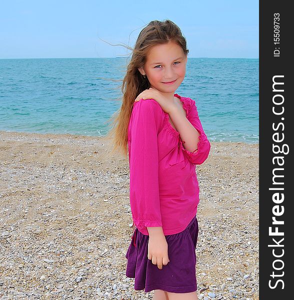 Happy girl by the sea in summer