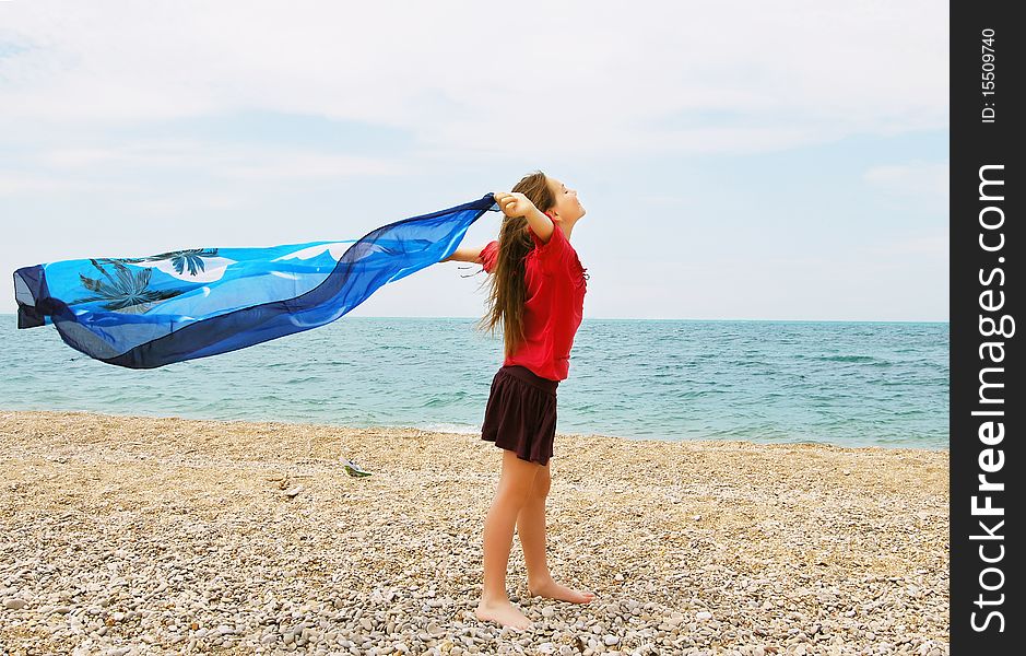 Happy girl by the sea in summer