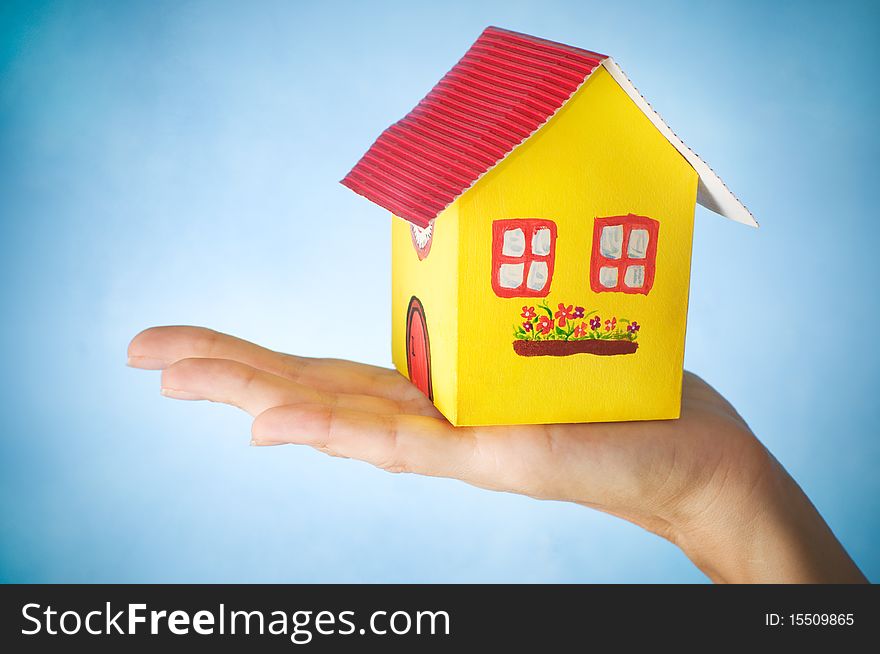 Woman holding a house in her hand. Woman holding a house in her hand