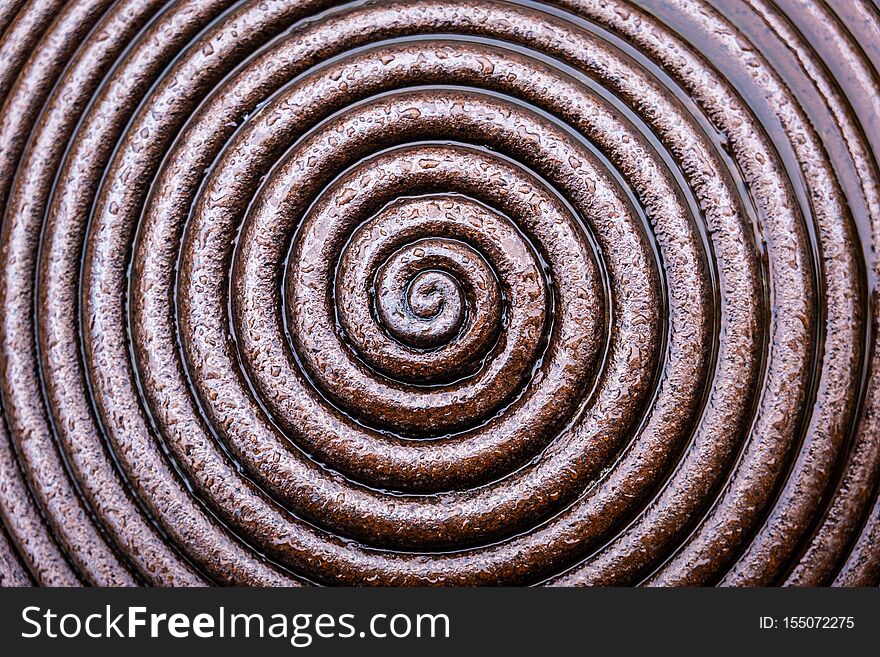 Wet metal spiral abstract background.