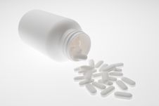 Pills And Bottle In White Stock Photo