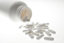 Pills And Bottle In White Stock Images