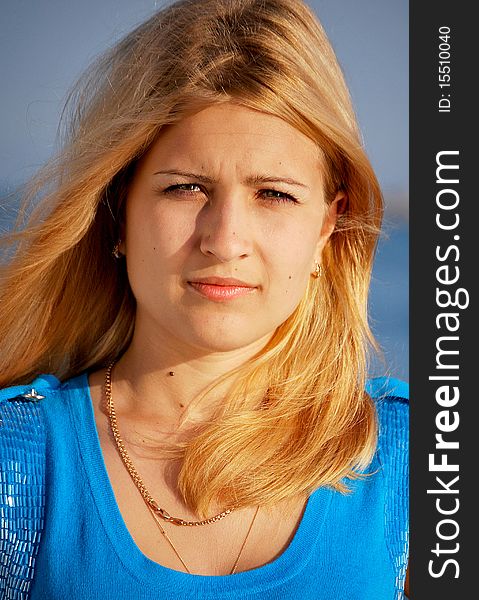 Young beautiful girl portrait by the ocean. Young beautiful girl portrait by the ocean