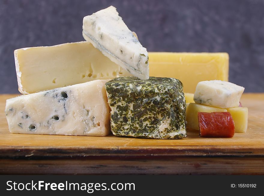 Cheese antipasto varieties on wooden chopping board