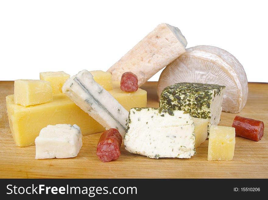 Cheese antipasto varieties on wooden chopping board isloated