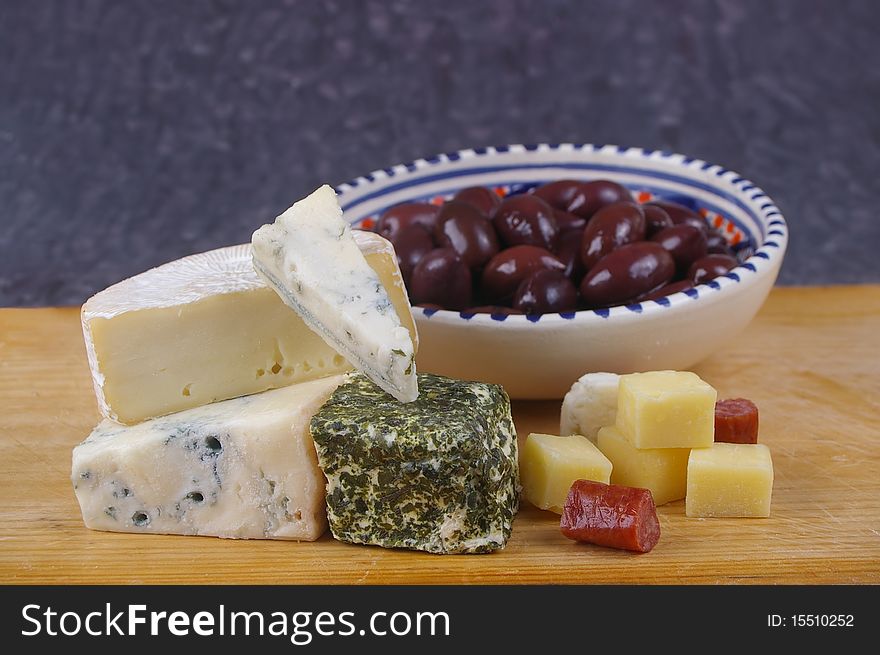 Cheese antipasto varieties on board with kalamata olives. Cheese antipasto varieties on board with kalamata olives