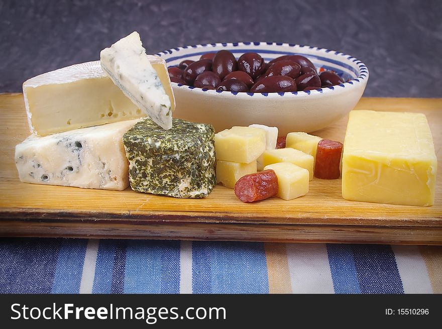 Cheese antipasto varieties on board with kalamata olives. Cheese antipasto varieties on board with kalamata olives