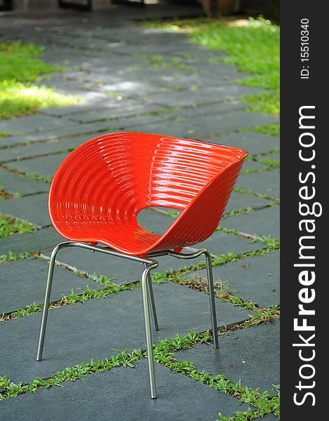 Red chair in rock garden