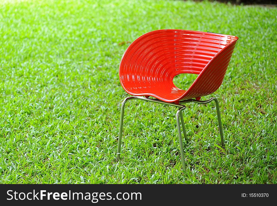 Red chair in green garden