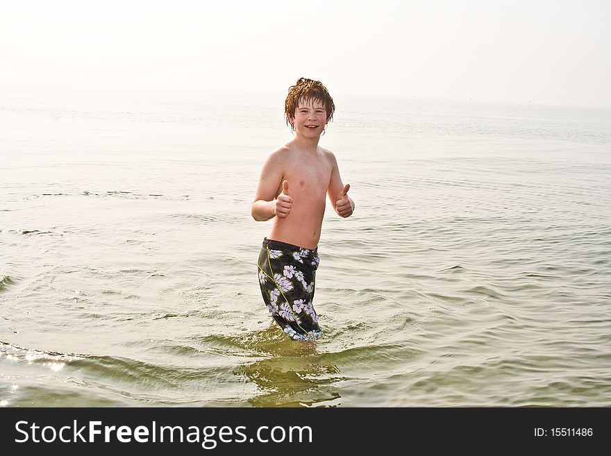 Young boy in the sea in cold water