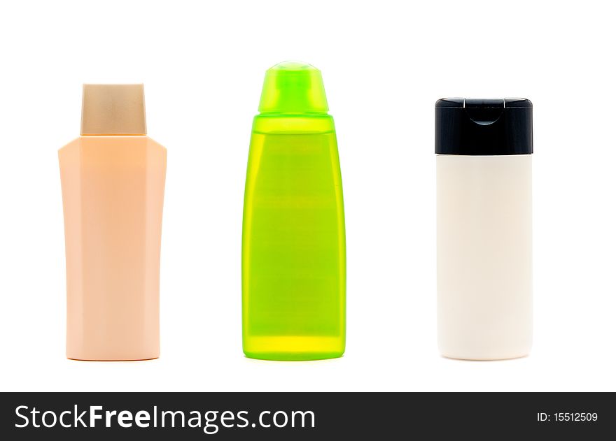 Three blank cosmetic bottles on white