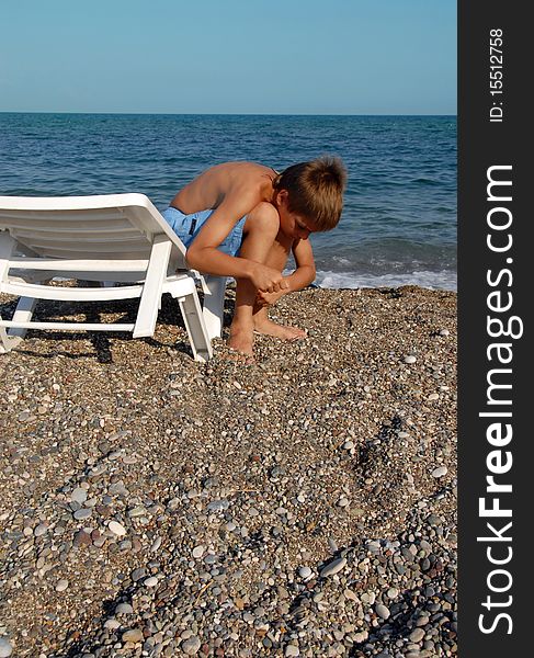 Boy playing in pebble