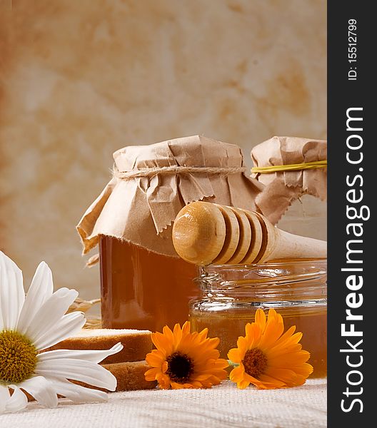 Several flowers and honey on sackcloth