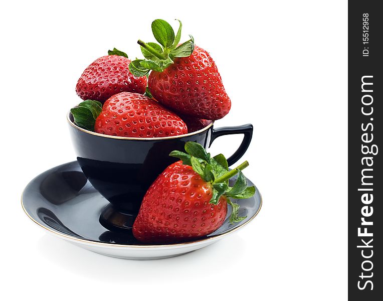 Fresh strawberries in an antique black tea cup. Fresh strawberries in an antique black tea cup