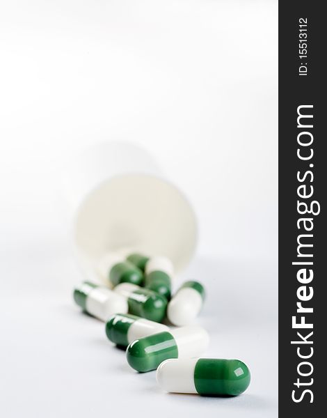 Pack of green capsules isolated on white background
