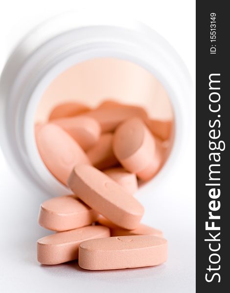 Closeup of a pack of pink pills, isolated on white