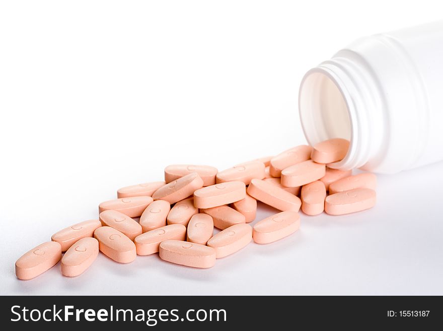 Closeup of a pack of pink pills, isolated on white