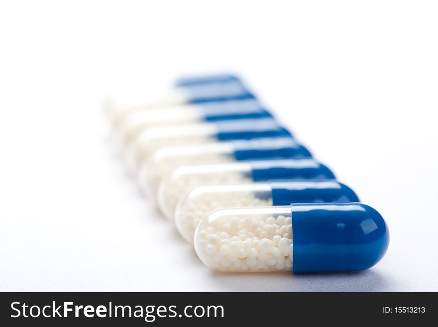 Close-up Of Blue Medical Capsules Isolated