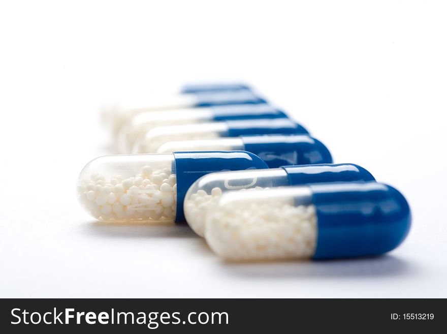 Close-up Of Blue Medical Capsules Isolated