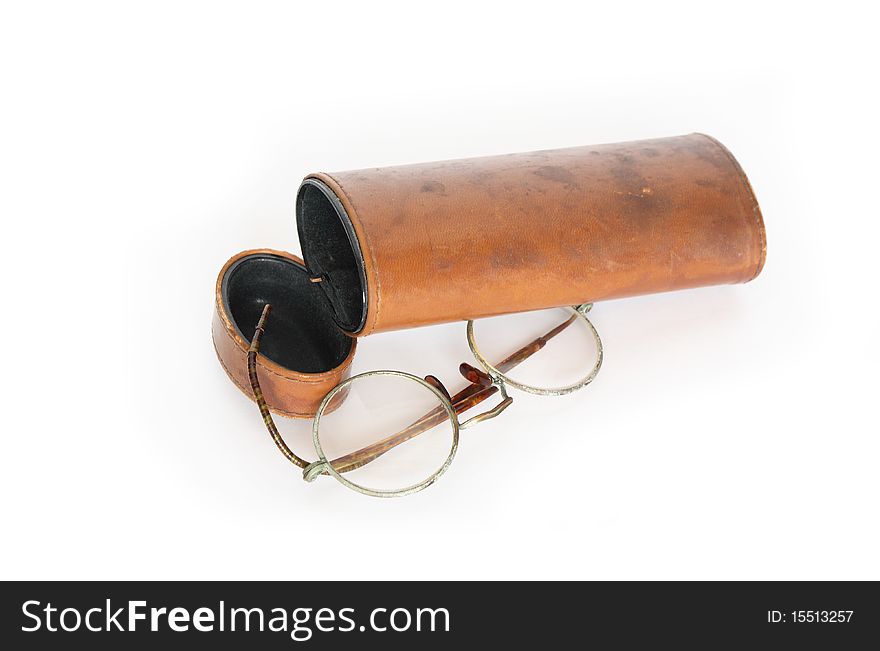 Old spectacles and vintage ginger leather case on white background