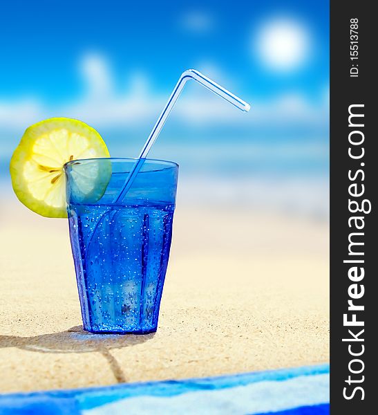 Glass Of Sparkling Water On A Beach